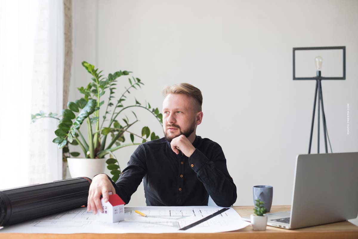 portrait-male-architect-with-house-model-architect-plan-workplace